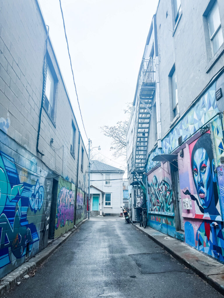 an alleyway with panted murals