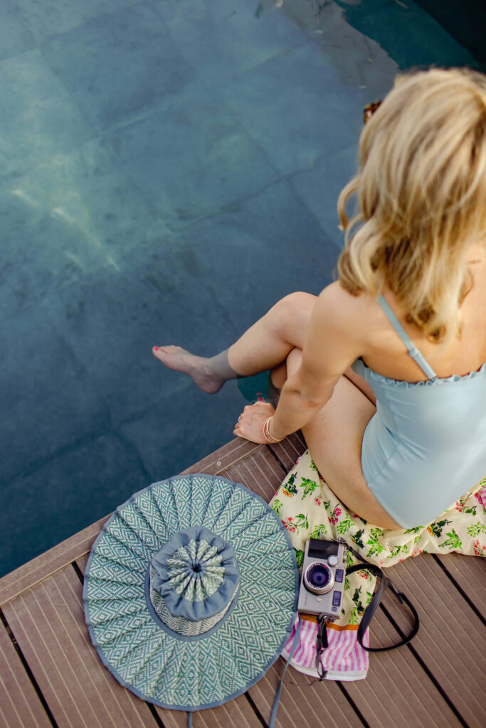 blonde woman sitting with her feet in the water