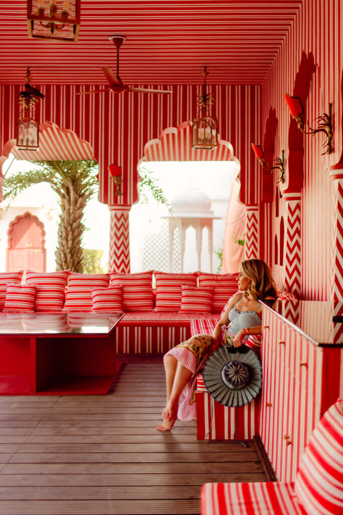 woman sitting in a large red room