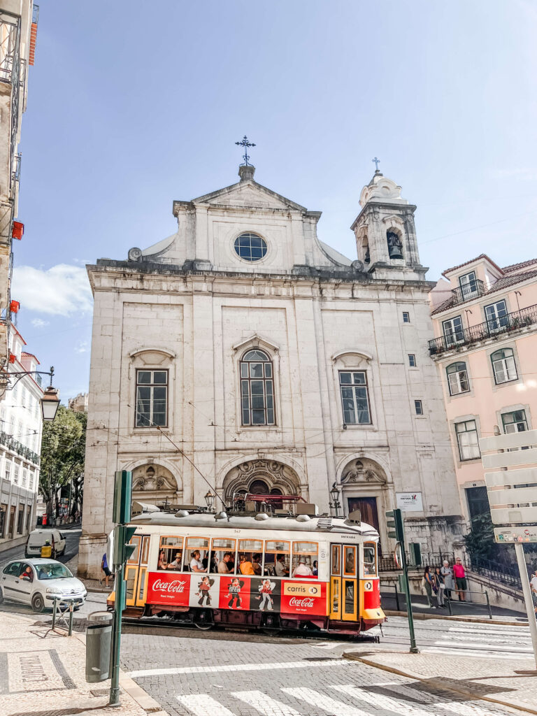 the tram 28 by a church in alfama