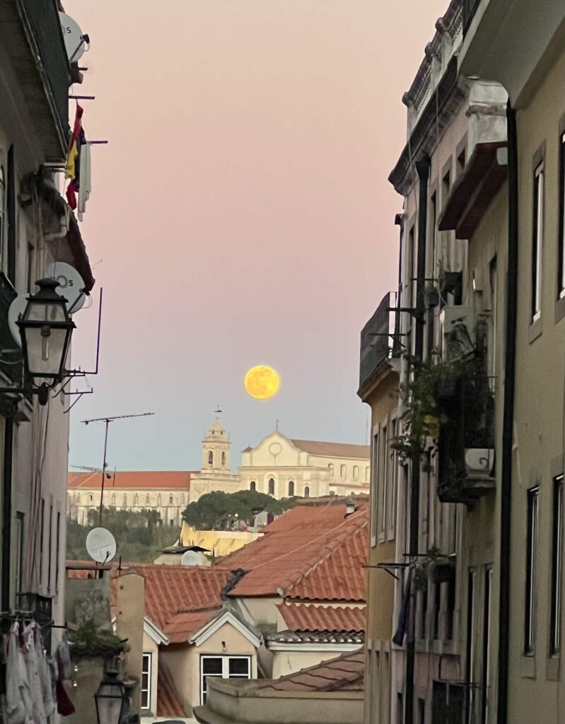 Moon poking out in Lisbon, Portugal.