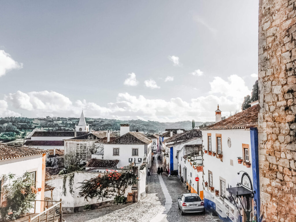 outside one of the bookstores looking down the mainstreet of obidos