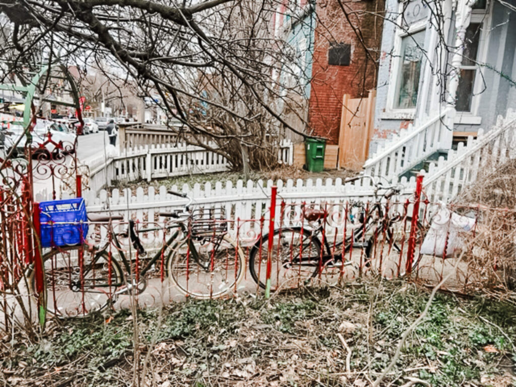 bikes against a white picket fence