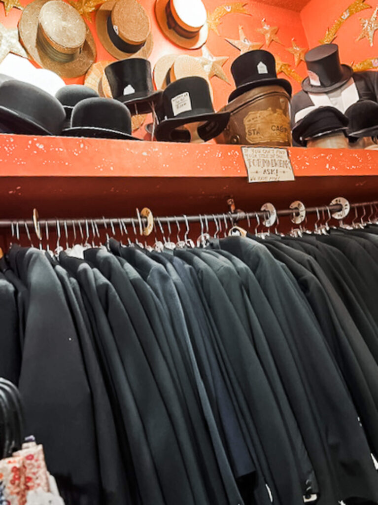 top hats and fancy jackets in thrift store