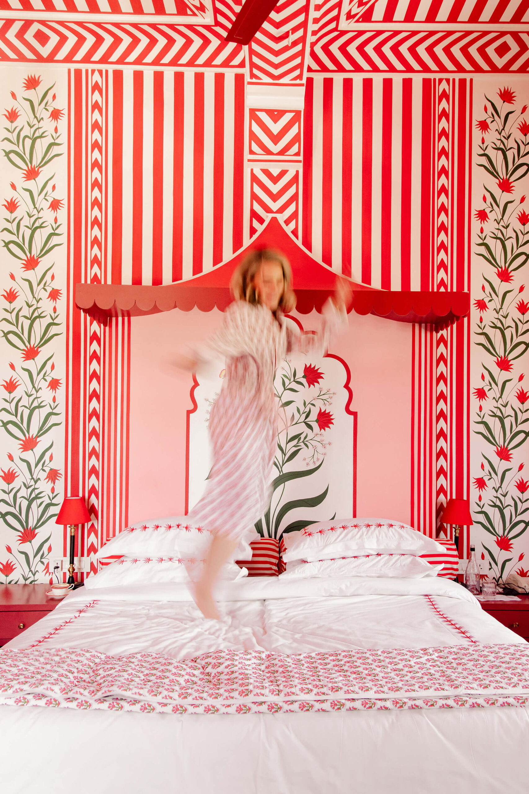 Woman jumping on a bed because happiness is a choice